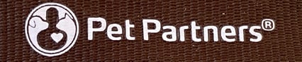 Close up of the Pet Partners brown lanyard, showing the Pet Partners name and logo