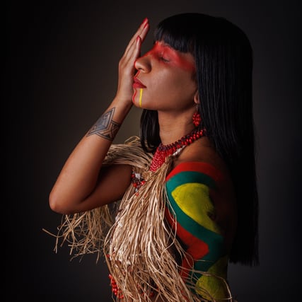 a woman with a colorful dress and a feathered headdress