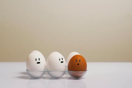 three eggshells with faces drawn on them