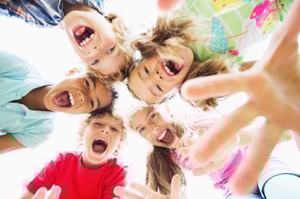 a group of children standing in a circle