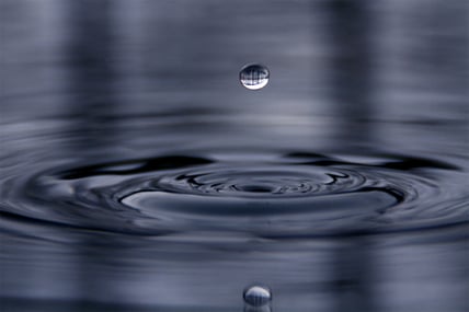 a drop of water in a pool of water