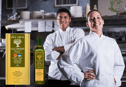 two chefs in white uniforms standing in a kitchen