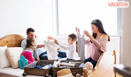 a family of four people packing suitcases