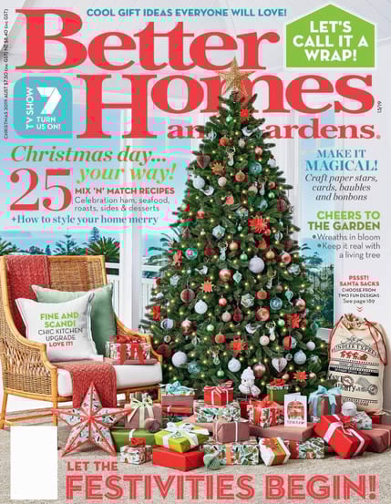 a christmas tree in a living room with presents for the holidays