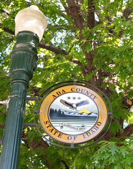 Street light with the Ada County seal displayed in Boise.