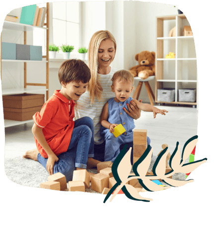 a woman and two children playing with blocks