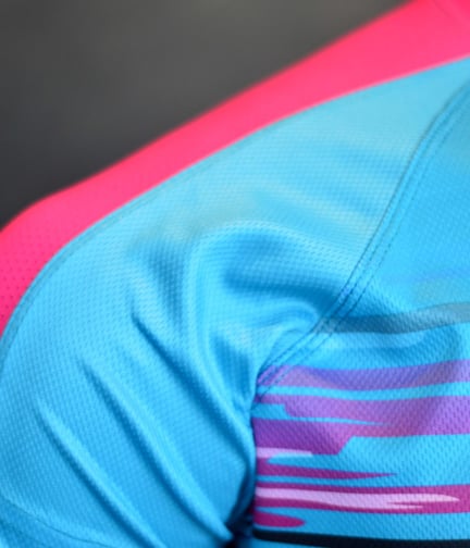 a close up of a blue and pink shirt with a pink and blue shirt