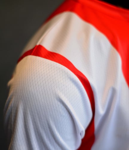 a close up of a man's shirt with a red and white shirt