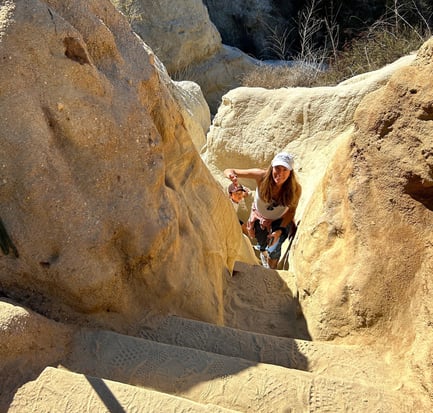 the author's mother climbing the staircase at the end of Annie's Canyon Trail. 