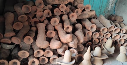 "A pile of wax-moulded brass sculptures covered with special clay, ready for casting in traditional Dhokra art from Bastar"