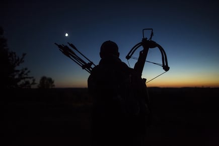 a man holding a bow and a bow