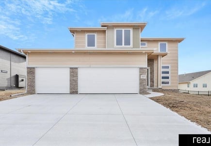 light brown two story home with 2 garages