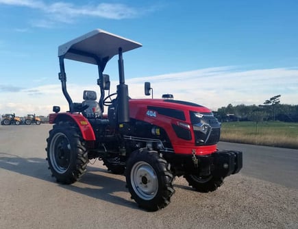 a red tractor with a canopy over it