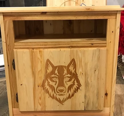 a wooden cabinet with a wolf head on it