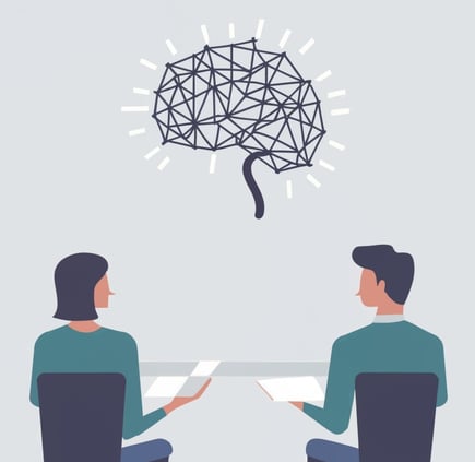 a man and woman sitting at a table with a brain map of a brain