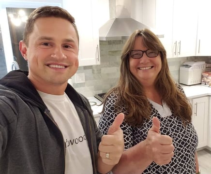 Happy customer posing with Alex, Vision Flooring. On the background brand new kitchen