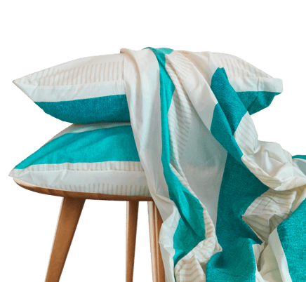 a stack of pillows and a bedsheet on a stool - cotton bedsheet
