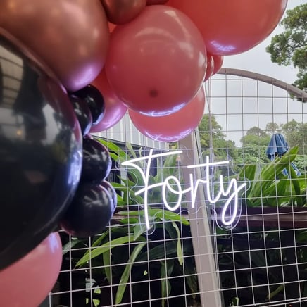Forty neon sign on a circle backdrop for Violet's 40th birthday in Redland Bay.