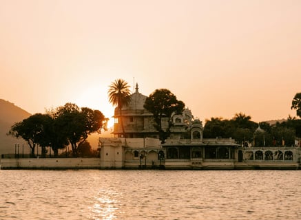 a boat in the water with a sunset in the background