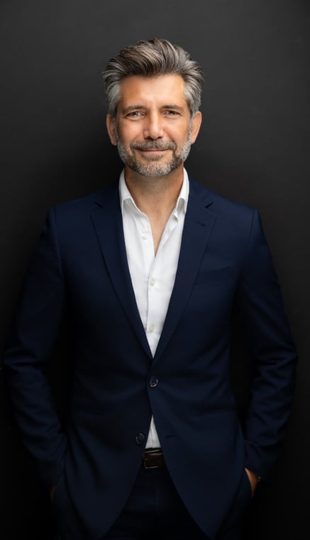 a man in a suit and white shirt
