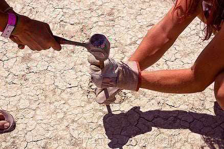 People hammering anchor to the playa dirt
