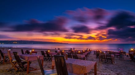 a beach with a table setting for dinner