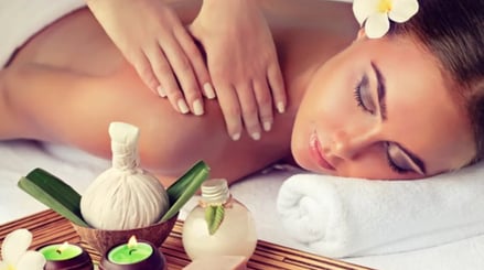a woman getting a massage at a spa