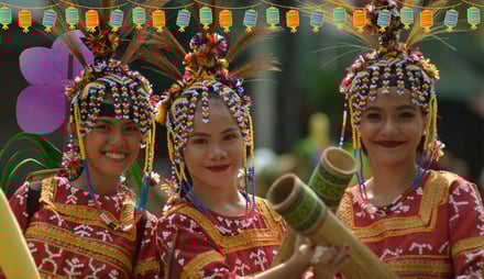 three women in colorful costumes at a local festival