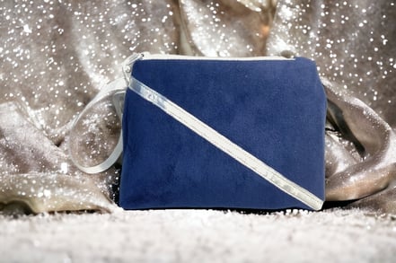 a blue bridsmaid purse with a white ribbon and a silver ribbon