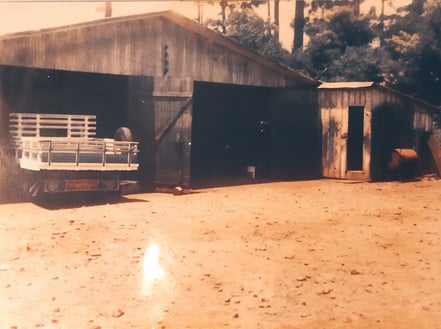 a truck parked in front of a barn