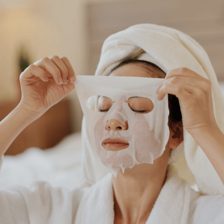 Girl using overnight mask in her k-beauty night skincare routine.