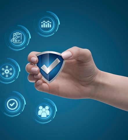 Hand holding a safety icon with checkmark – symbolizing pharmacovigilance compliance and oversight