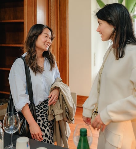 Two women sharing a conversation during a fertility support event.