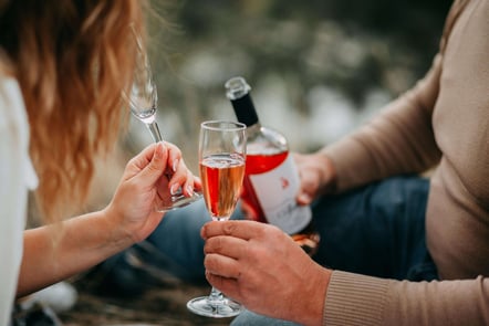 a man and woman holding wine glasses