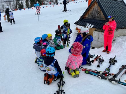 a group of children in skis and snow gear