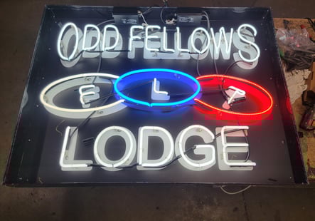 a neon sign that says ODD FELLOWS LODGE