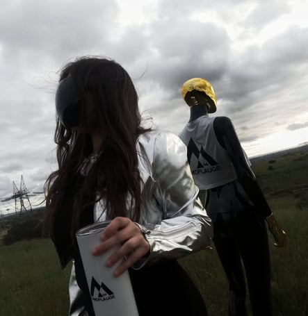 a woman in a silver jacket and a dimensional being