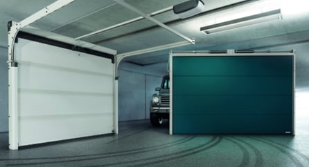 a truck parked in a garage with a green door