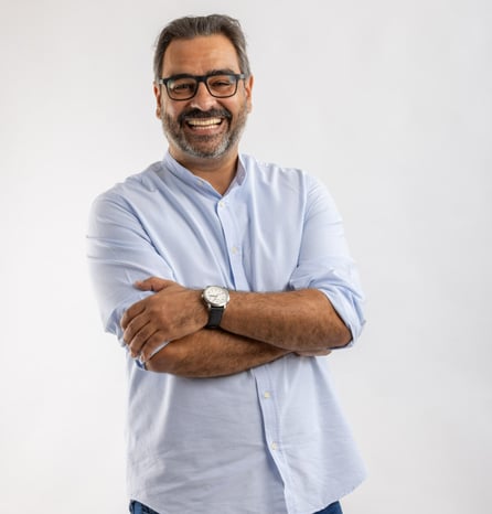 a man with glasses and a watch on his wrist