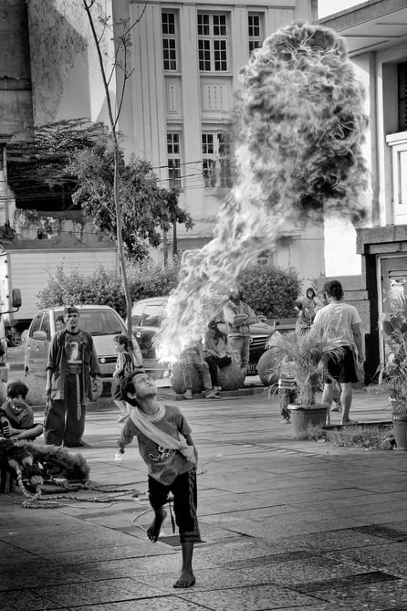 Petrol-fueled flame spitting by Indonesian boy in the lens of Peter Pickering