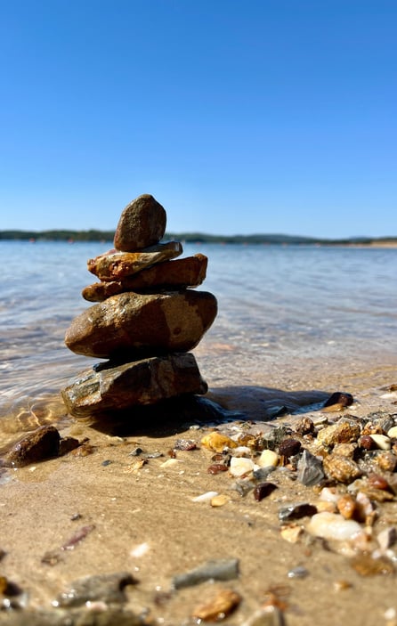 a stack of rocks sitting on the beach