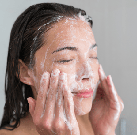 woman exfoliating her face