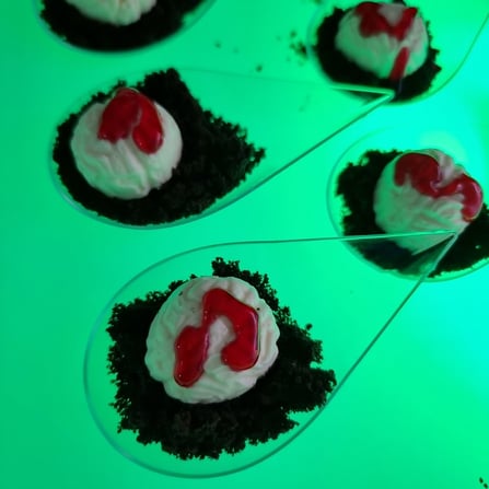 SweetAz Co. LED glow serving tray with individual Halloween-themed treats of brain cheesecake on Oreo cookie dirt.