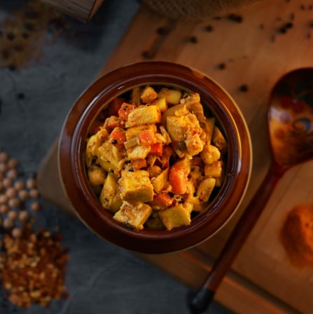 a bowl of food with a wooden spoon and a wooden spoon