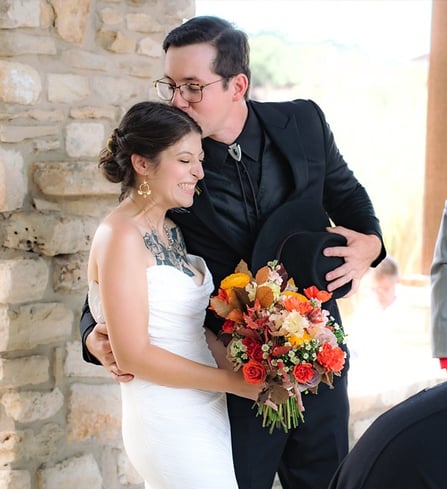 a man and woman standing in altar