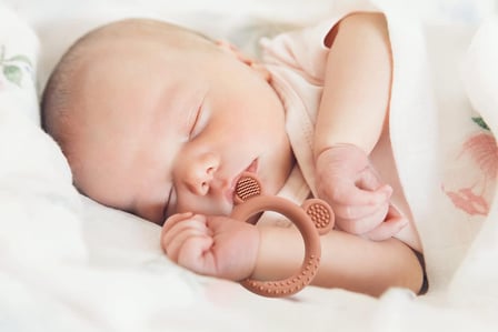 baby with teething ring