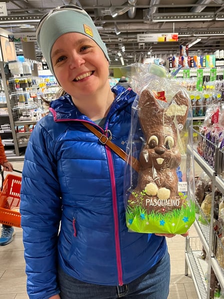 Picture of Corinne from Hidden Switzerland Travel holding a chocolate easter bunny