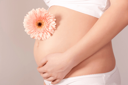 a pregnant woman with a flower in her belly