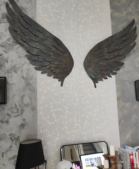 Ailes décoratives métalliques brun foncé sur mur gris clair
