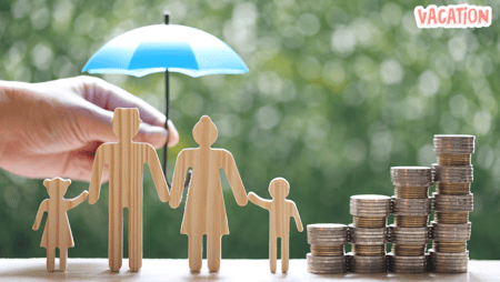 a person holding a blue umbrella over a stack of coins